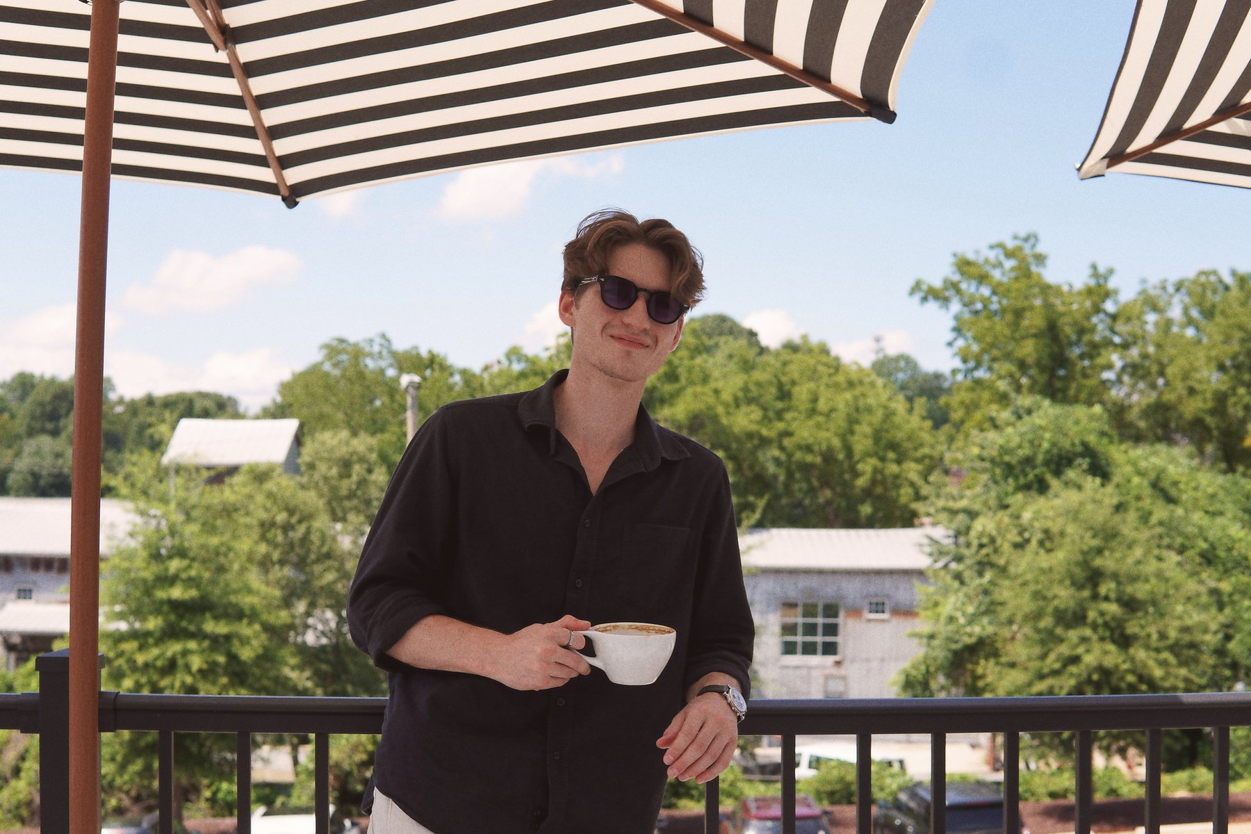 Marshall Huff with an espresso on a cafe balcony in Mocksville