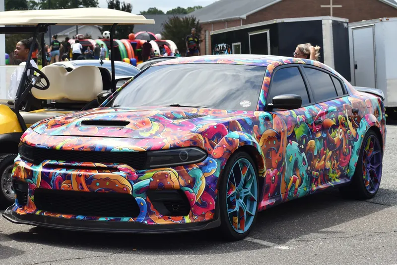 A wrapped Dodge Charger on the lot at Eats on 601 in Mocksville